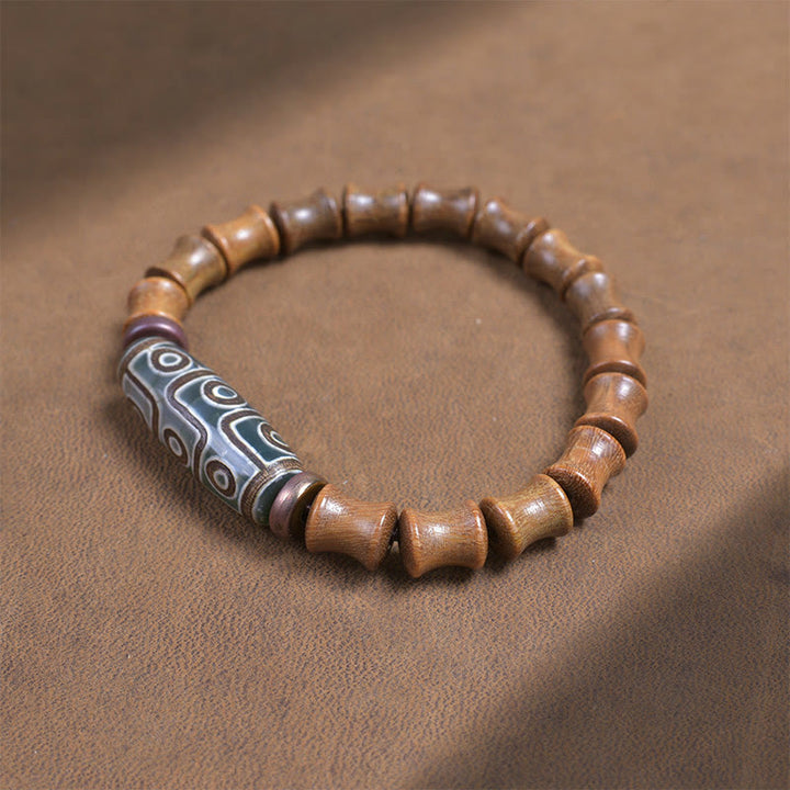 Buddha Stones Tibetisches Neun-Augen-Dzi-Perlen-Friedensarmband aus grünem Sandelholz