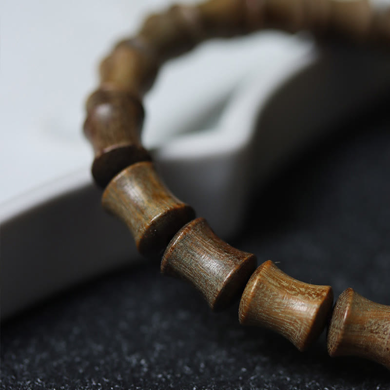 Buddha Stones Tibetisches Neun-Augen-Dzi-Perlen-Friedensarmband aus grünem Sandelholz
