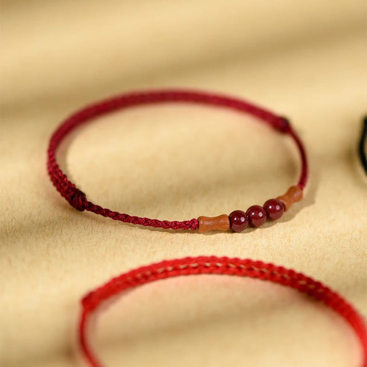 Buddha Stones Zinnoberperlen Pfirsichholz Segensschnur Armband