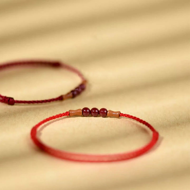 Buddha Stones Zinnoberperlen Pfirsichholz Segensschnur Armband