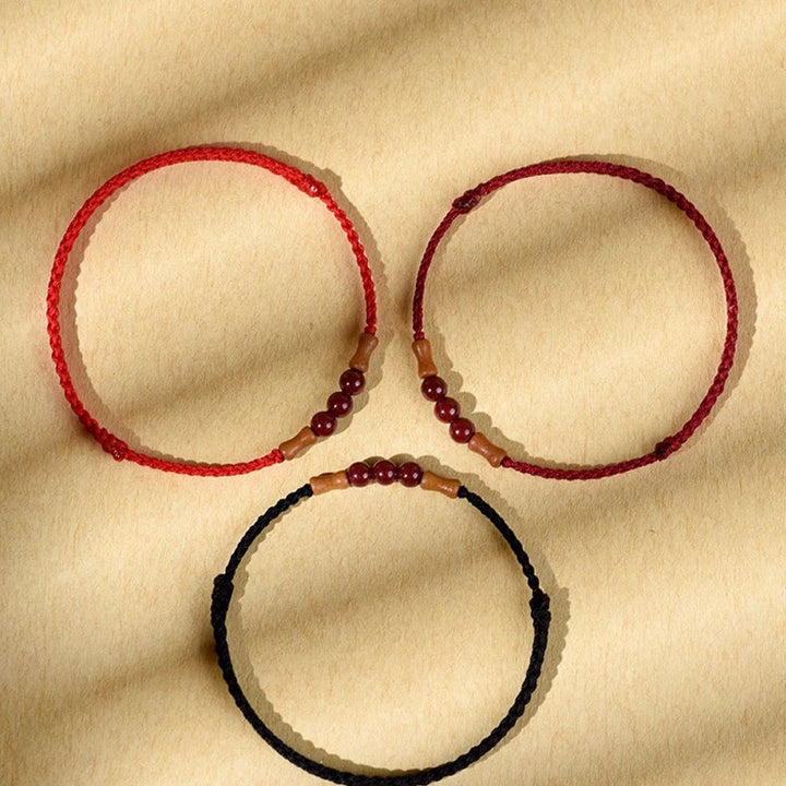 Buddha Stones Zinnoberperlen Pfirsichholz Segensschnur Armband