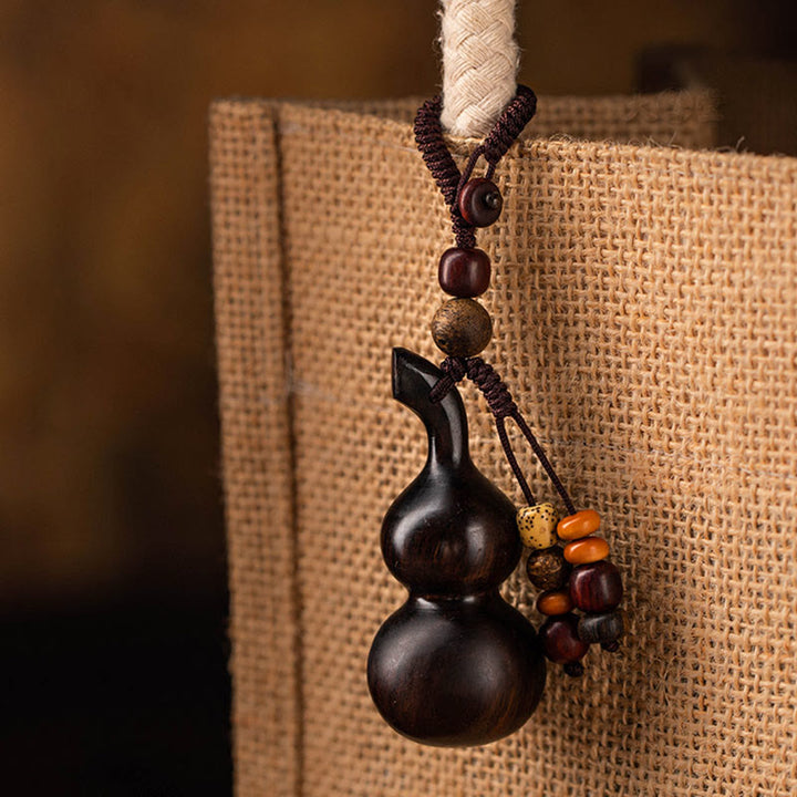 Schlüsselanhänger aus tibetischem Ebenholz, kleinem Blatt, rotem Sandelholz, Kürbis, Glücksschutz