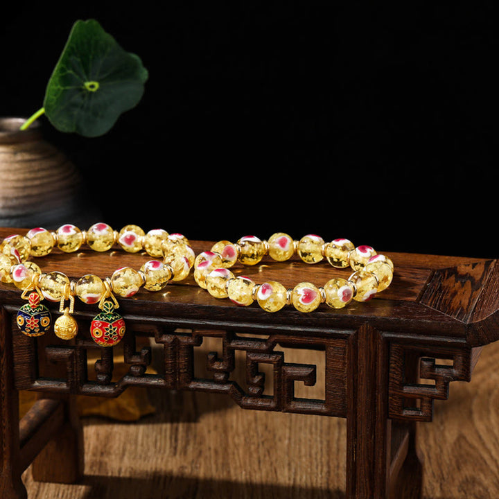 Buddha Stones Gold Schluckendes Biest Familie Rosa Liebesherz Leuchtendes fluoreszierendes Liuli-Glasperlenarmband