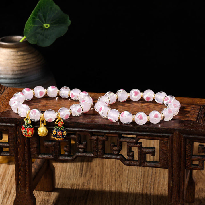 Buddha Stones Gold Schluckendes Biest Familie Rosa Liebesherz Leuchtendes fluoreszierendes Liuli-Glasperlenarmband