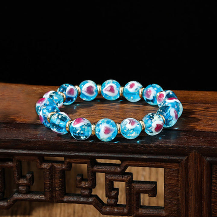 Buddha Stones Gold Schluckendes Biest Familie Rosa Liebesherz Leuchtendes fluoreszierendes Liuli-Glasperlenarmband