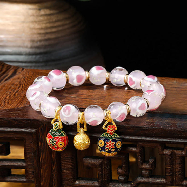 Buddha Stones Gold Schluckendes Biest Familie Rosa Liebesherz Leuchtendes fluoreszierendes Liuli-Glasperlenarmband