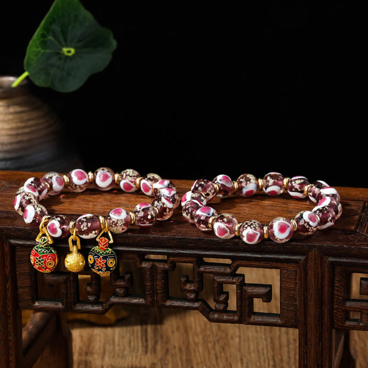 Buddha Stones Gold Schluckendes Biest Familie Rosa Liebesherz Leuchtendes fluoreszierendes Liuli-Glasperlenarmband