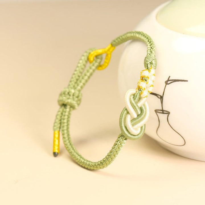 Buddha Stones Handgefertigtes achtfädiges Friedensknoten-Pfirsichblütenknoten-Glücksverbindungsarmband