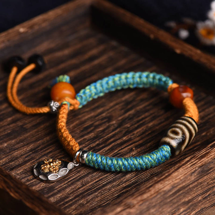 Handgemachtes geflochtenes Armband aus tibetischen Dzi-Perlen mit Buddha Stones