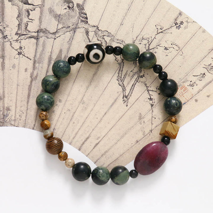 Buddha Stones Armband mit dreiäugigen Dzi-Perlen aus grünem Achat und Krafterfolg