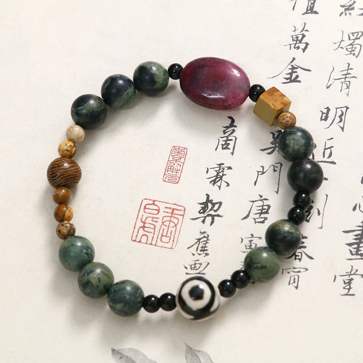 Buddha Stones Armband mit dreiäugigen Dzi-Perlen aus grünem Achat und Krafterfolg