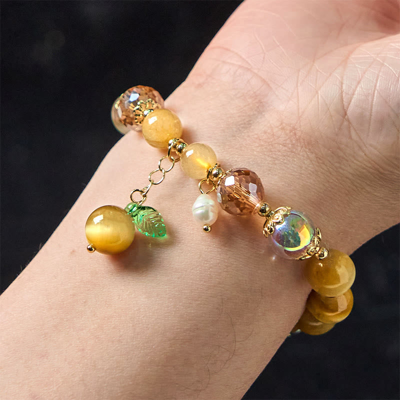 Buddha Stones Armband mit natürlichen Tigeraugen-Perlen und grünem Blattmotiv
