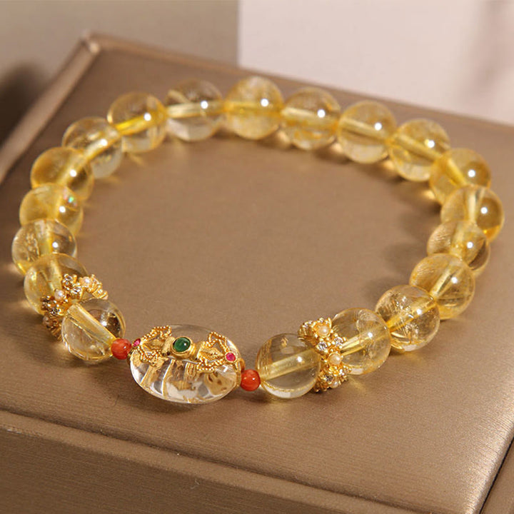Buddha Stones Armband mit natürlichen goldenen Rutilquarzperlen und Glücksbringer