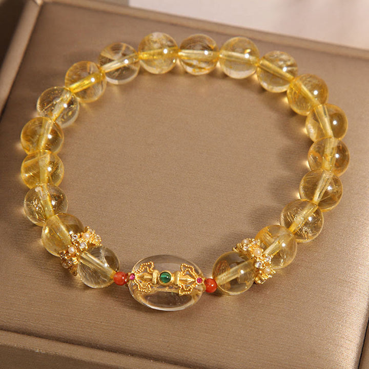 Buddha Stones Armband mit natürlichen goldenen Rutilquarzperlen und Glücksbringer