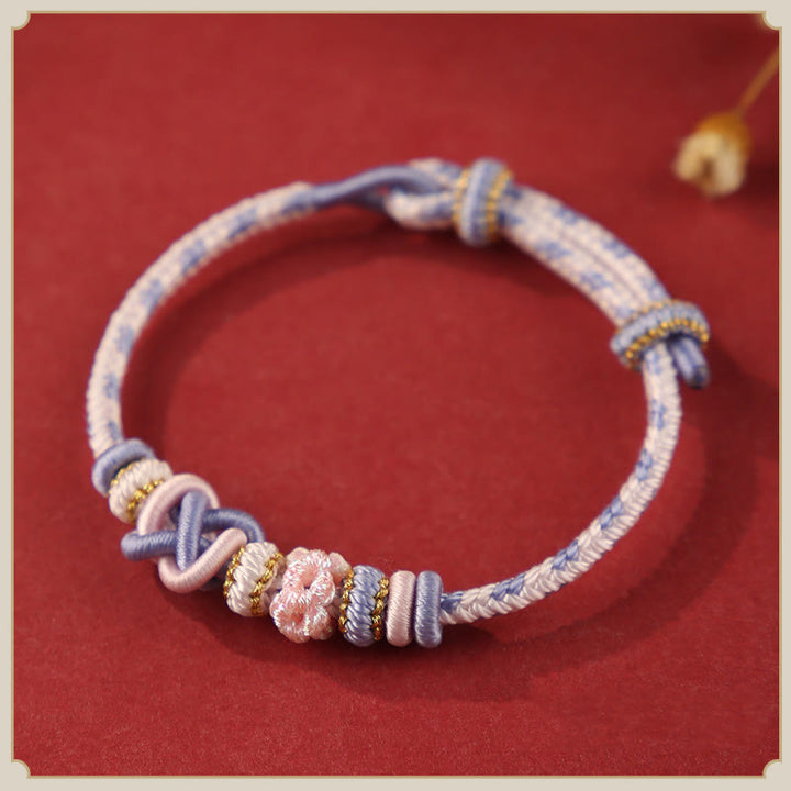 Buddha Stones Handgefertigtes Pfirsichblüten-Friedensknoten-Armband mit buntem Seil, verstellbar