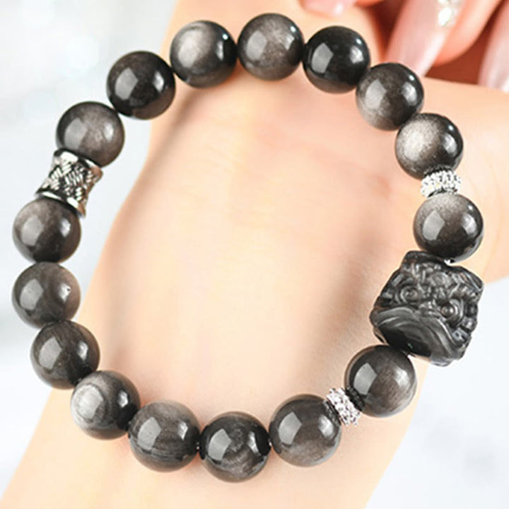 Buddha Stones Schutzarmband mit natürlichem Silberglanz-Obsidian und Löwentanz