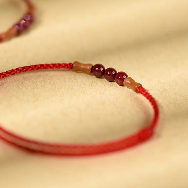 Buddha Stones Zinnoberperlen Pfirsichholz Segensschnur Armband