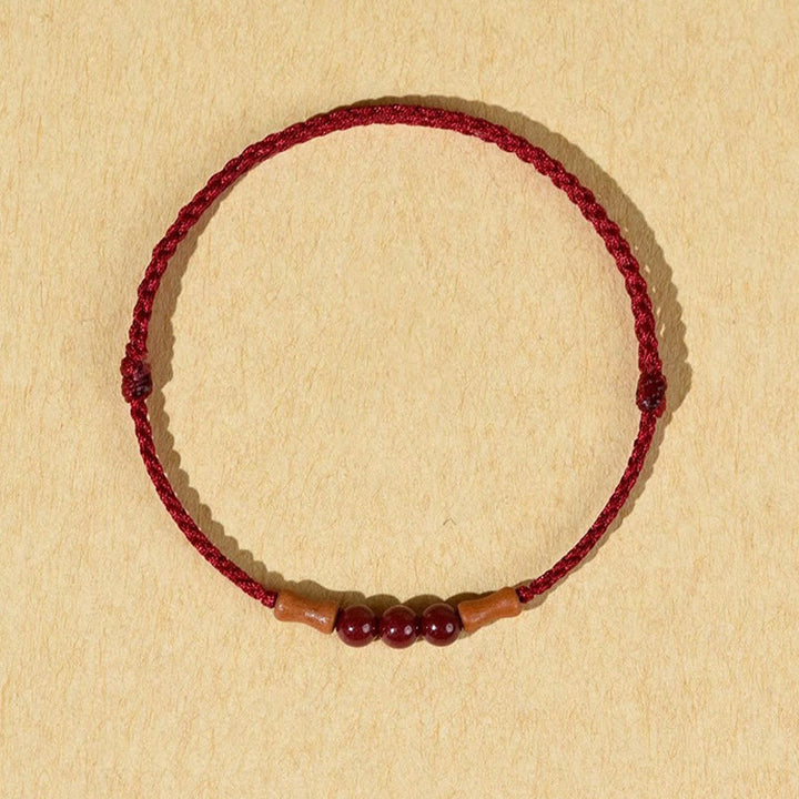 Buddha Stones Zinnoberperlen Pfirsichholz Segensschnur Armband