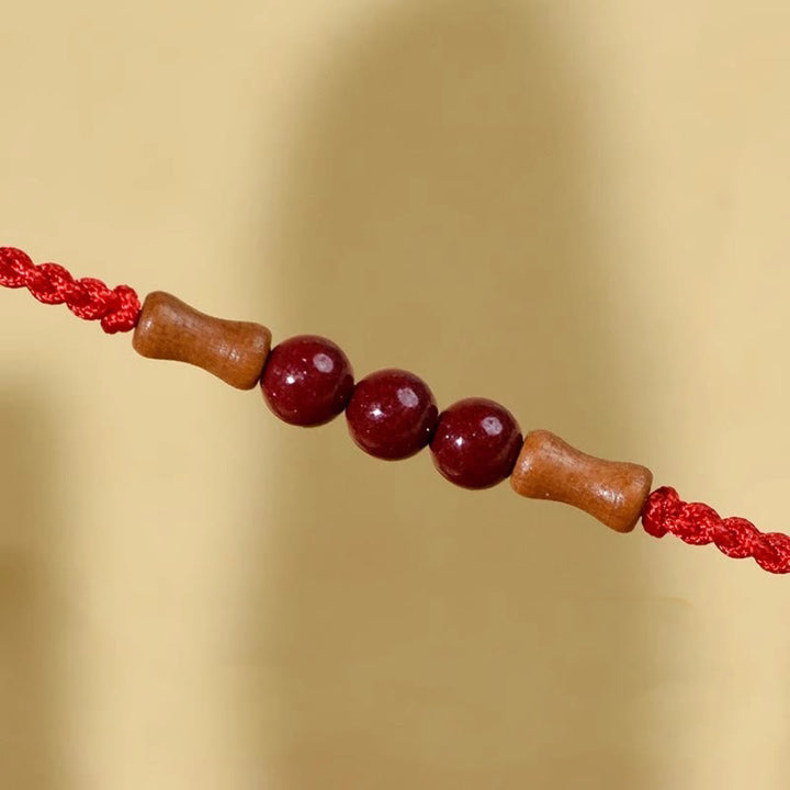 Buddha Stones Zinnoberperlen Pfirsichholz Segensschnur Armband