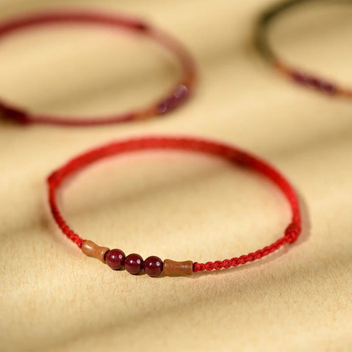 Buddha Stones Zinnoberperlen Pfirsichholz Segensschnur Armband