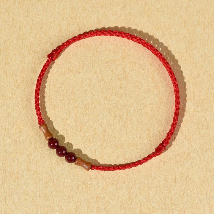 Buddha Stones Zinnoberperlen Pfirsichholz Segensschnur Armband