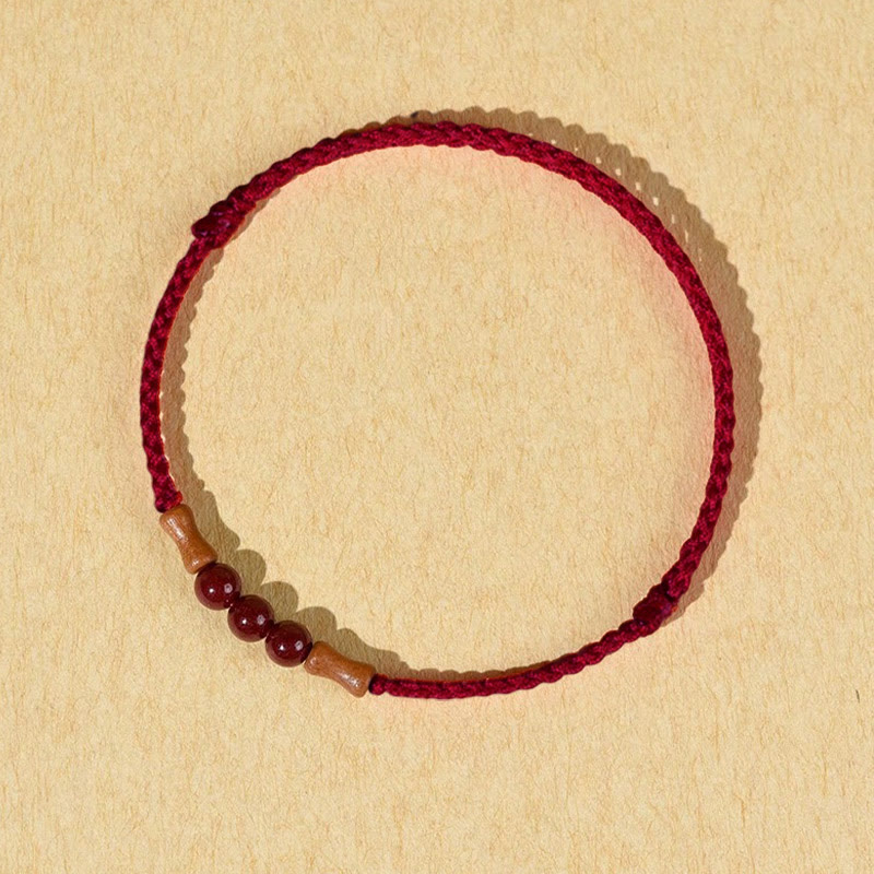 Buddha Stones Zinnoberperlen Pfirsichholz Segensschnur Armband