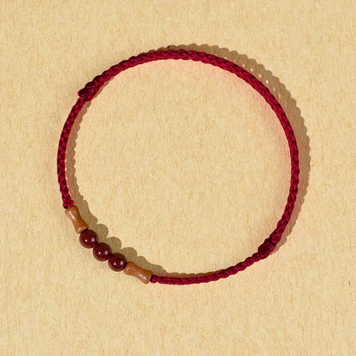 Buddha Stones Zinnoberperlen Pfirsichholz Segensschnur Armband