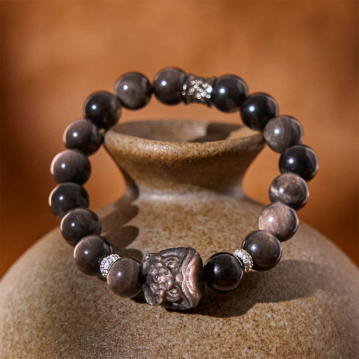 Buddha Stones Schutzarmband mit natürlichem Silberglanz-Obsidian und Löwentanz