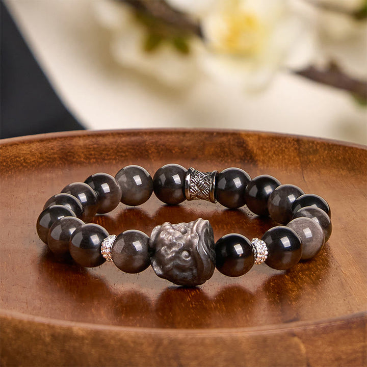 Buddha Stones Schutzarmband mit natürlichem Silberglanz-Obsidian und Löwentanz