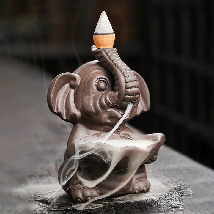 Buddha Stones, kleiner Elefant, hält Blatt, lila Ton, Rückfluss-Rauchbrunnen, heilende Weihrauchbrenner-Dekoration - image 1