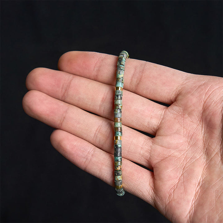 Armband mit türkisfarbenen Buddha Stones und Zwischenperlen zur Reinigung
