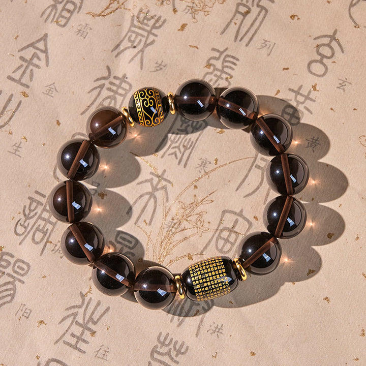 Buddha Stones Eisobsidian Sanskrit-Mutarmband mit Goldprägung