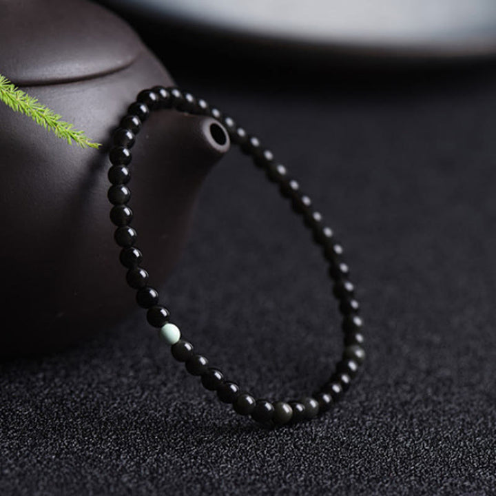 Buddha Stones aus schwarzem Obsidian und Türkis – Symbol für Stärke und Erfüllung - image 2