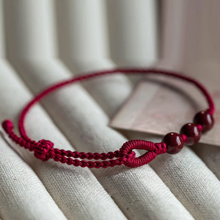 Buddha Stones Handgefertigtes Armband aus geflochtenem Seil mit Zinnoberperlen und dem Spruch „Ruhe und Segen“. - image 3