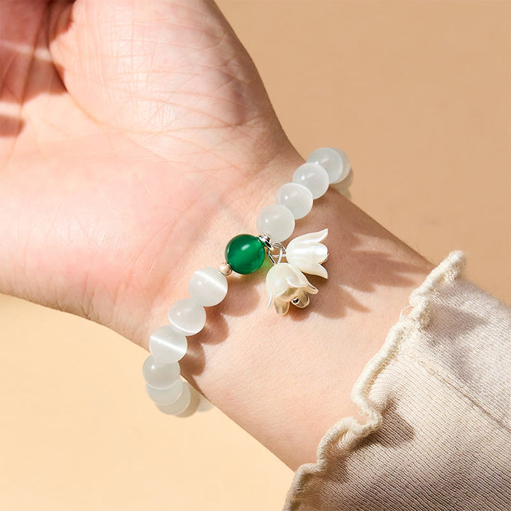 Buddha Stones 8 mm weiße Katzenaugenperlen, rund, Maiglöckchen-Armband - image 2