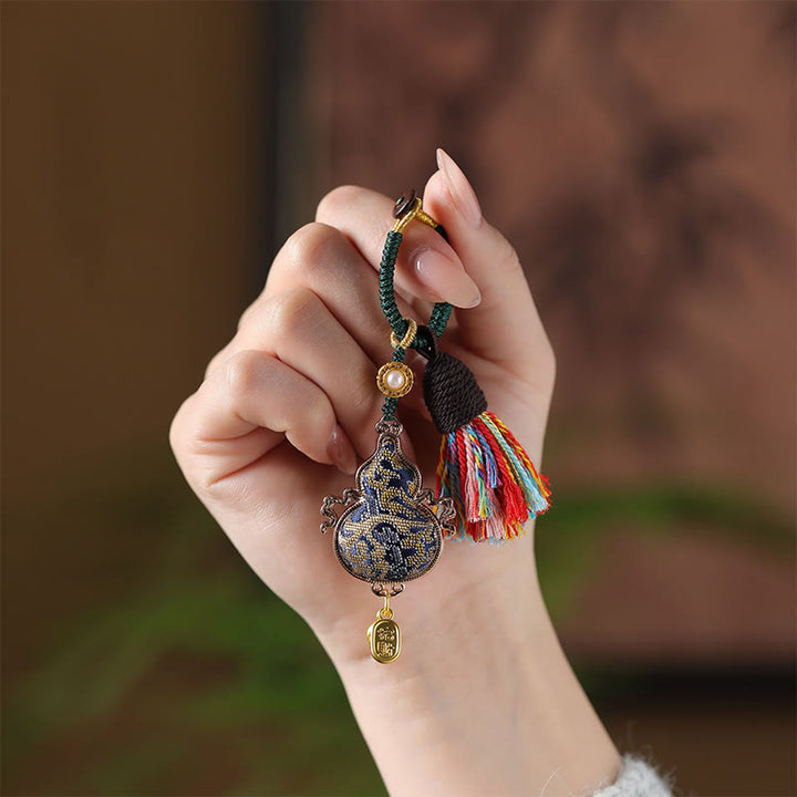 Buddha Stones Schlüsselanhänger aus Brokatkürbis mit Liedmotiv - image 1