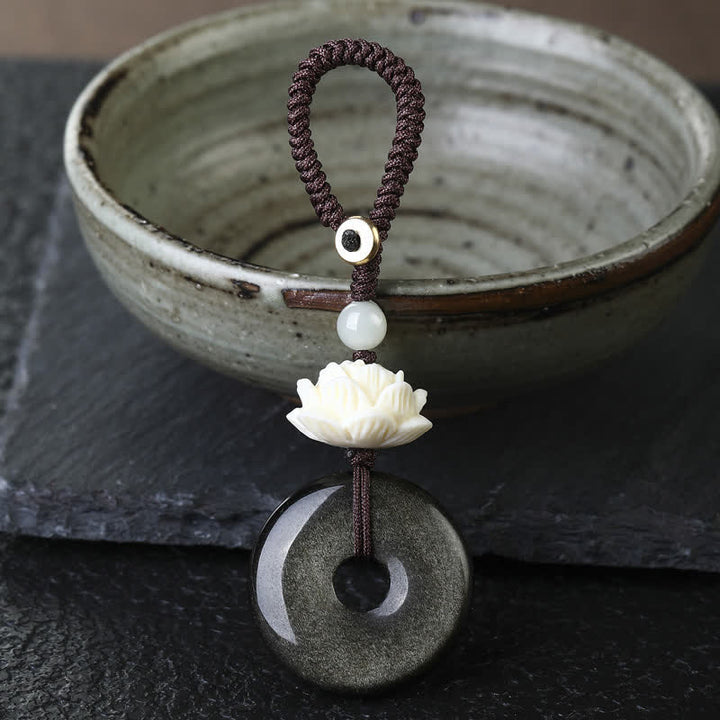 Buddha Stones Regenbogen-Obsidian-Lotus-Friedensschnallen-Schutz-Schlüsselanhänger - Lotus - Goldener Obsidian-Friedensschnallen-Schlüsselanhänger - Regenbogenobsidian (Farbveränderungen im Licht) - image 0