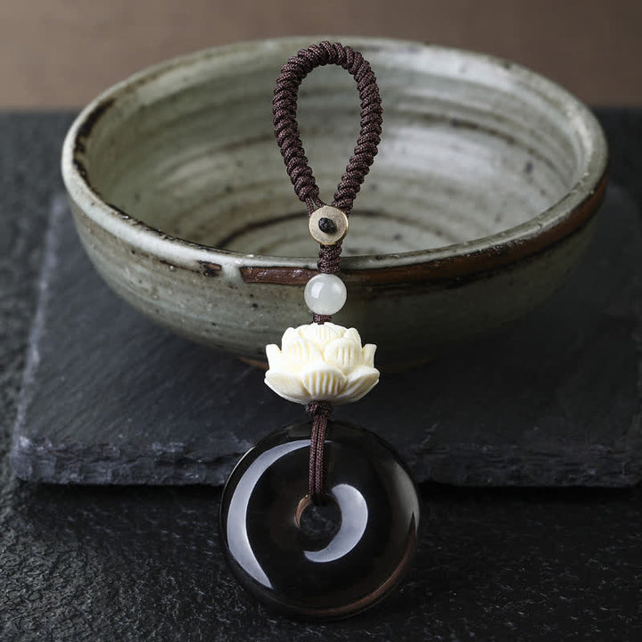 Buddha Stones Regenbogen-Obsidian-Lotus-Friedensschnallen-Schutz-Schlüsselanhänger - Lotus - Friedensschnalle aus Eisobsidian-Schlüsselanhänger - Regenbogenobsidian (Farbveränderungen im Licht) - image 1