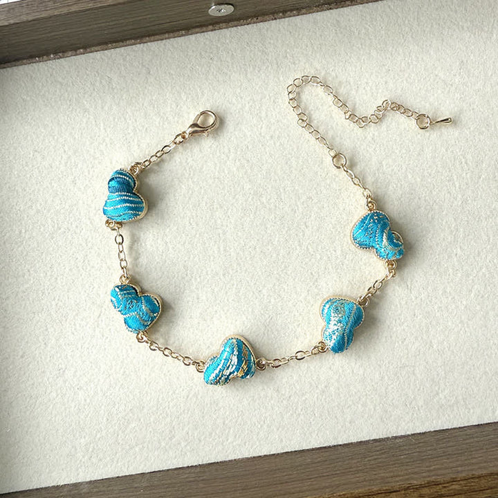 Buddha Stones Armband aus Brokat, Kupferkürbis und Goldton mit Segensmotiv - Blau (gleicher Farbton – Muster variiert) - image 3