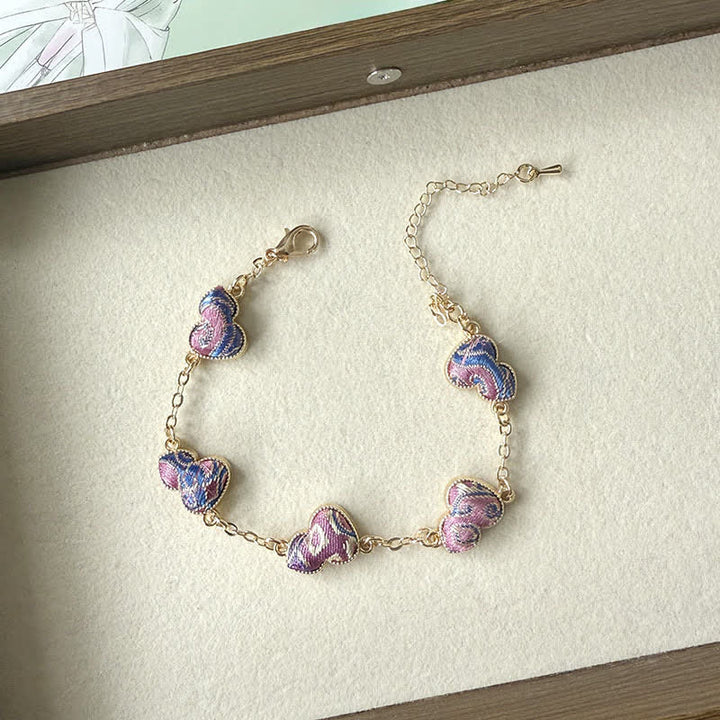 Buddha Stones Armband aus Brokat, Kupferkürbis und Goldton mit Segensmotiv - Lila (gleicher Farbton – Muster variiert) - image 0