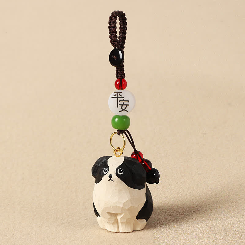 Buddha Stones Schlüsselanhänger mit geschnitztem Hund aus Holz und der Weisheit Om Mani Padme Hum - Sicherer schwarz-weißer Hund - image 1