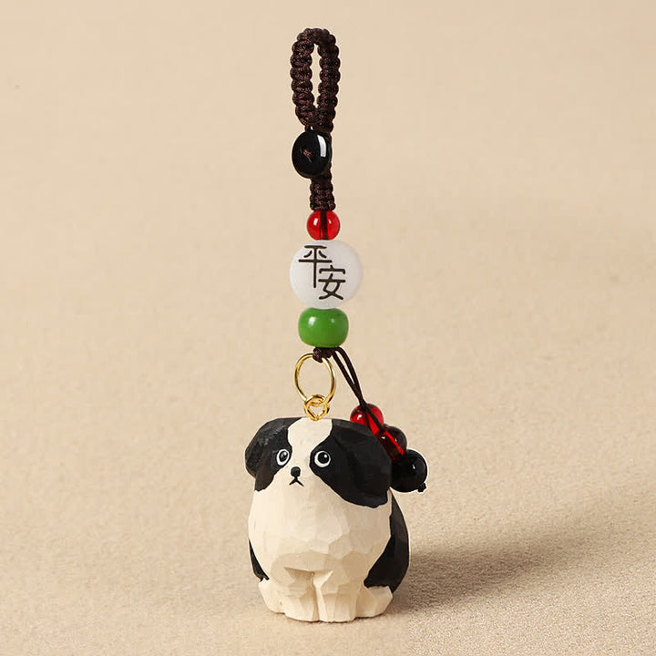 Buddha Stones Schlüsselanhänger mit geschnitztem Hund aus Holz und der Weisheit Om Mani Padme Hum - Sicherer schwarz-weißer Hund - image 1