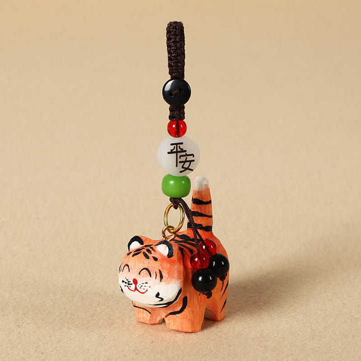 Buddha Stones Schlüsselanhänger aus geschnitztem Holz: Tiger, Om, Mani, Padme, Hum, Fokus - Sicherer Tiger - image 1