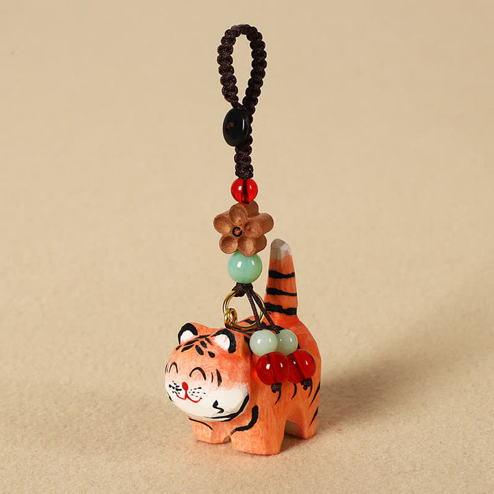 Buddha Stones Schlüsselanhänger aus geschnitztem Holz: Tiger, Om, Mani, Padme, Hum, Fokus - Tiger - image 0