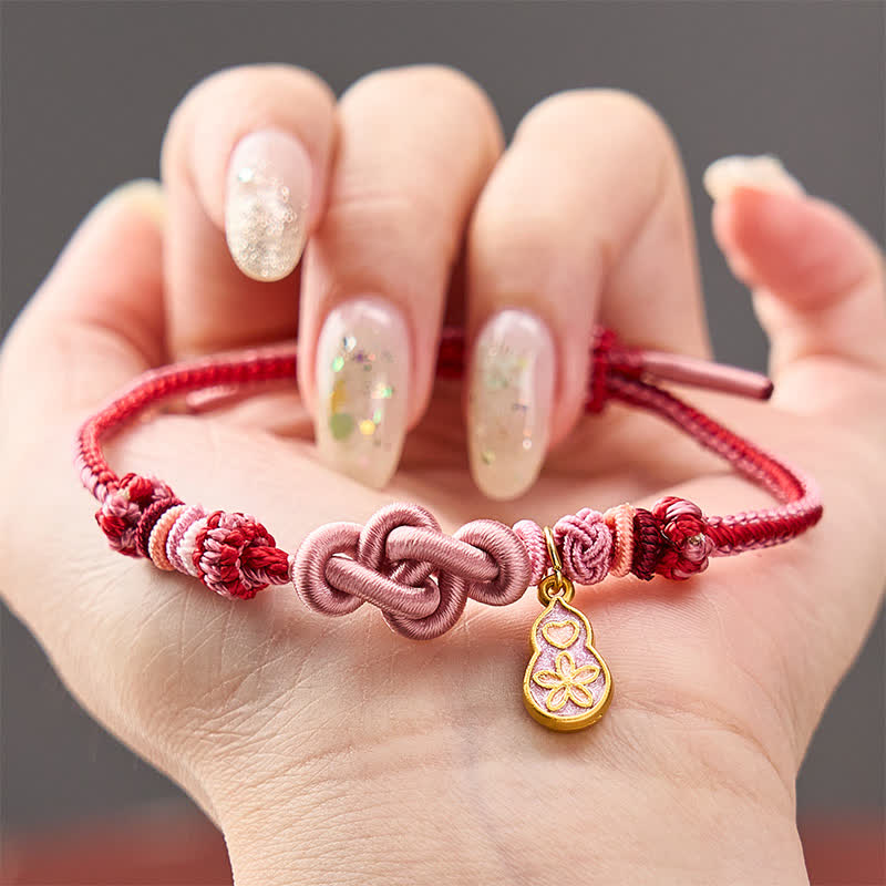 Buddha Stones Handgewebtes Armband aus rosafarbenem Kordelstoff mit dem Aufdruck „Schnell reich werden“ - Rosa mit Kürbis-Accessoire - image 0