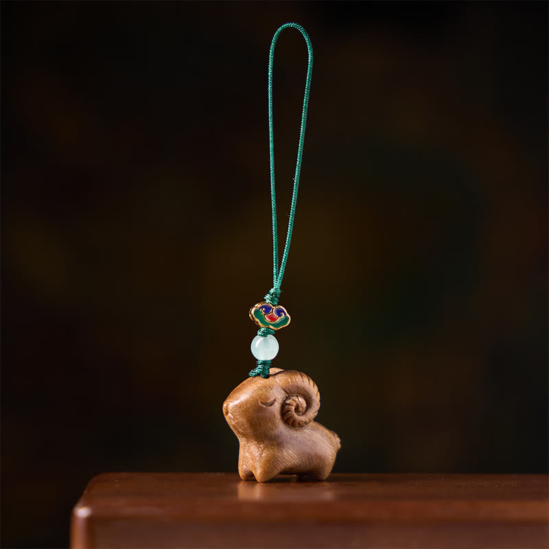 Buddha Stones Handgeschnitzte Schlüsselanhänger aus Sandelholz mit Ziegenmotiv - image 1