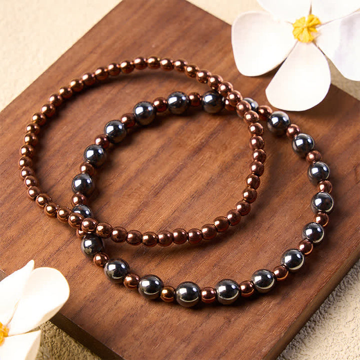 Buddha Stones 2-teiliges Set: Minimalistisches Armband aus runden Hämatitperlen für mehr Erdung - image 1