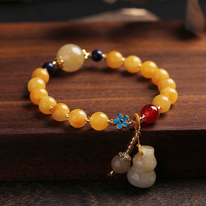 Buddha Stones Armband aus natürlicher goldener Seide mit Kürbis-Charm Wealth Luck