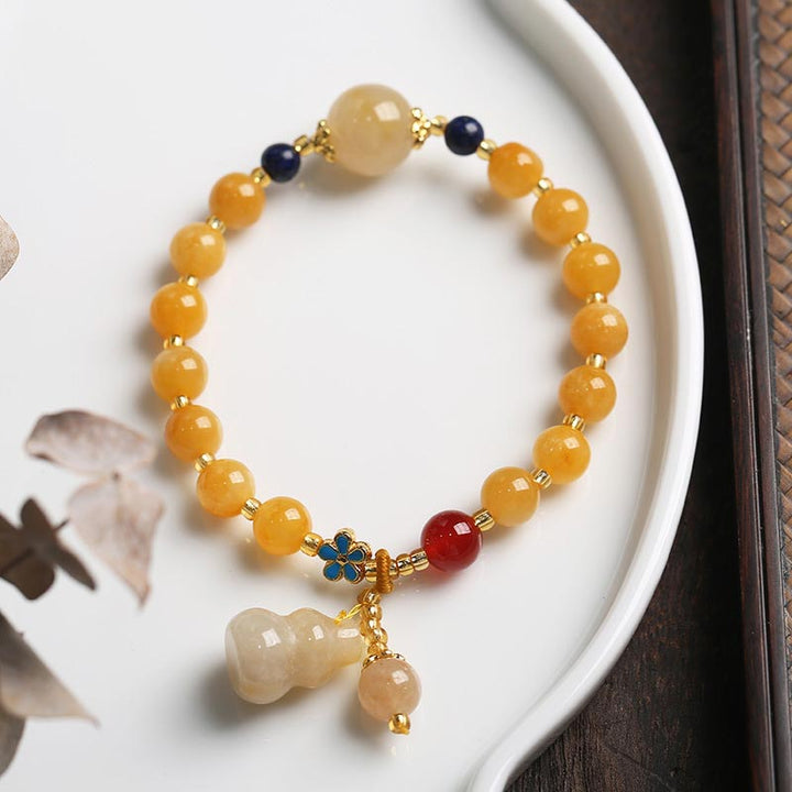 Buddha Stones Armband aus natürlicher goldener Seide mit Kürbis-Charm Wealth Luck