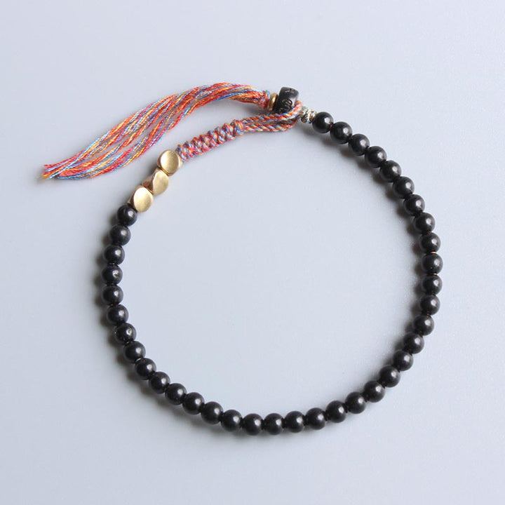 Buddha Stones Handgefertigtes tibetisches schwarzes Onyx-Quastenarmband